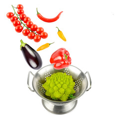 Vegetables fall into a colander to be washed. Composition isolated on white background. Collage.