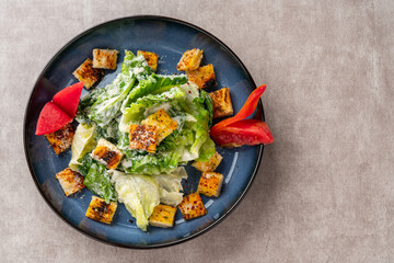 Caesar salad is a green salad of romaine lettuce and croutons dressed with mustard, Parmesan cheese, and garlic bread.