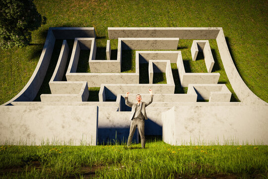 Successful man in the labyrinth - the concept of a difficult career path to a businessman's success - symbolism of the obstacle course