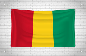 Guinea flag hanging on brick wall. 3D drawing. Flag attached to the wall. Neatly drawing in groups on separate layers for easy editing.