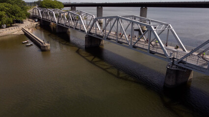 Aerial view of cyclist riding on the bridge during early morning hours.