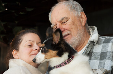 Expressives portraits of a grand father, young woman and shetland puppy