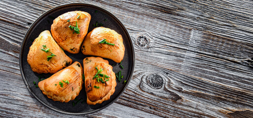 Composition with a plate of oven-baked pierogi