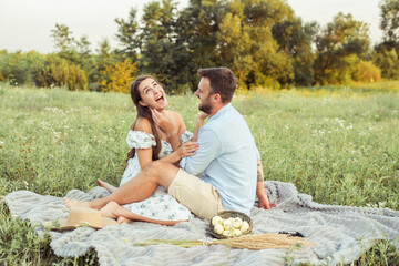 woman and bearded man on field nature picnic