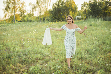 woman in field in nature with a straw hat