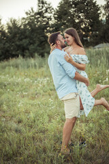 woman and bearded man on field nature picnic