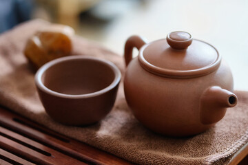 Traditional chinese tea ceremony utensils. Chinese brown clay teapot and cup. Tea brewing equipment