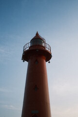 A red lighthouse illuminates Haeundae, Busan
