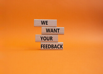 We want your feedback symbol. Wooden blocks with words We want your feedback. Beautiful orange background. We want your feedback concept. Copy space.