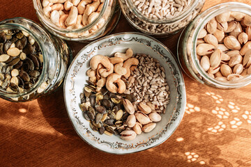 Cashew nuts, pistachios, sunflower and pumpkin seeds in a bowl on the table.