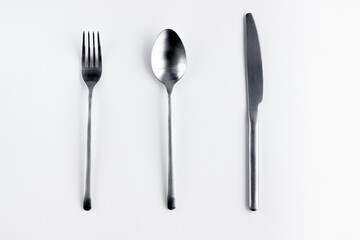Silver fork, spoon, knife isolated on white.