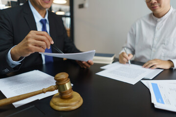 Lawyer and justice concept, Businessman signs contract after senior lawyer explains details