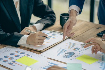 Business people meeting to analyze and discuss and brainstorm data, charts, financial reports and accounting in concept financial advisory office. teamwork