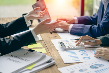 Business people meeting to analyze and discuss and brainstorm data, charts, financial reports and accounting in concept financial advisory office. teamwork