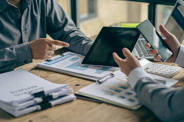 Business people meeting to analyze and discuss and brainstorm data, charts, financial reports and...