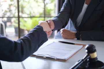 Cropped imaged of male lawyer shaking hands with client. Legal services, advice, justice and law...