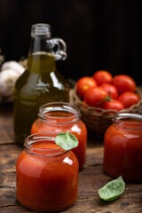 Fresh Tomato sauce and juice . On a wooden background.