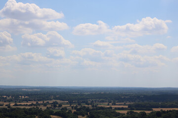 English countryside with field in foreground and blue sky with copy space