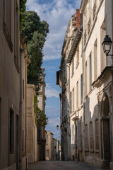 Scenic urban landscape view of typical narrow street and old buildings in the historic center of Montpellier, France in summer