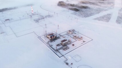 A drone flies over an oil and gas production facility during winter time during extremely low temperatures. A drone flies over the snow in Siberia where oil and gas are produced for sale to Europe