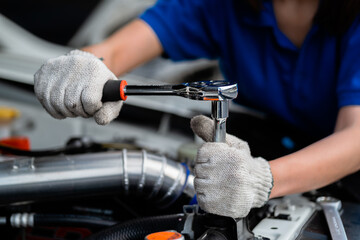 Close-up of an expert mechanic working on a vehicle in a car service. Engine. Motor repair. Auto mechanic. Auto mechanic.