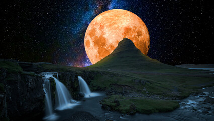 Moon behind the mountain with waterfall