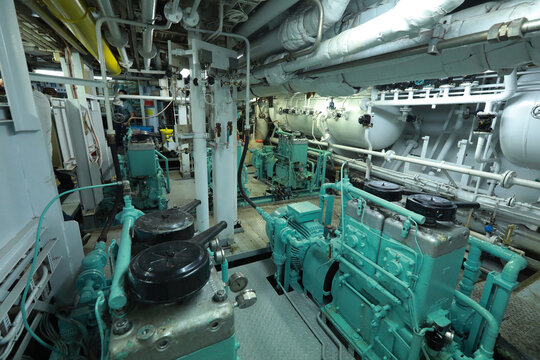 Cruise ship engine room interior with water tight doors electrical and diesel engines, water pipes, measuring instruments