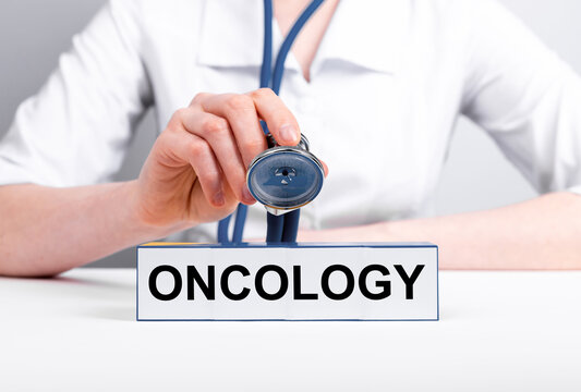 Oncology word. Cancer text in doctor hands. High quality photo