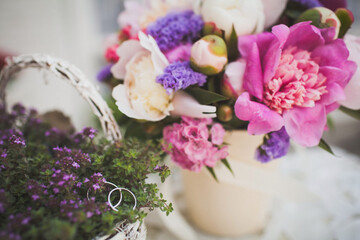 Obraz na płótnie Canvas Two wedding rings on flowers in a vase