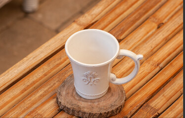 cup of coffee on wooden table  White vintage coffee cup on bamboo table