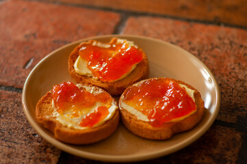 Fototapeta na wymiar toasts with apricot jam on a ceramic plate