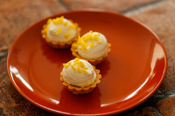 cake with cream mini cupcakes with lemon curd on a terracotta plate