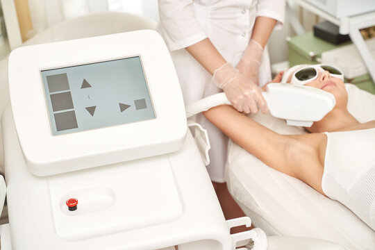 Laser hair removal treatment. Clinic skin care procedure. Medical dermatology photo equipment. People epilation device. Cosmetology technology salon epilation. Body aesthetic concept. Ampit