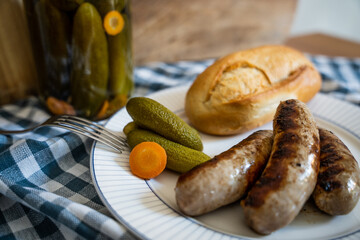 Roasted German sausages served with homemade pickled cucumbers and piece of bread 2