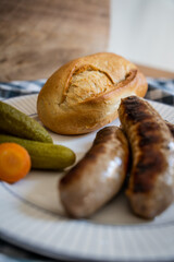 Detail of bread served with roasted German sausages and homemade pickled cucumbers