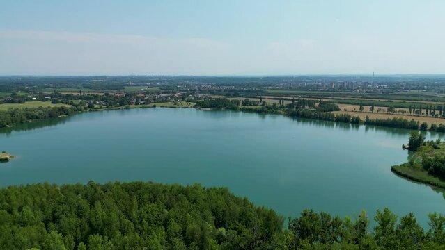 Arial air view on afloat gravel pit named Male Kalisovo jezero lake neat Bohumin city during spring afternoon with blue sky and few clouds