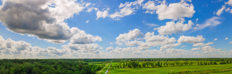 Fototapeta na wymiar Blue sky panorama with clouds over tops of green trees. Blue sky and white cloud soft. White clouds background.