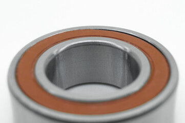 Closed type bearing for modern equipment and machines on a white background. Ball bearing with protective covers. Selective focus