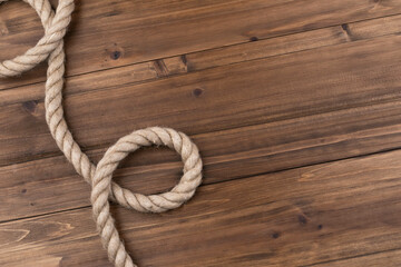 sail boat rope twisted up on wood background.