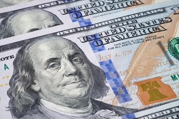 Obraz na płótnie Canvas President Benjamin Franklin on 100 US dollar bill. Glogal reserve currency. Cash money. Currency background. Closeup view.