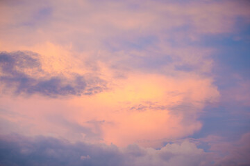 Sunset sky with colorful clouds. Blue colors merge with soft orange