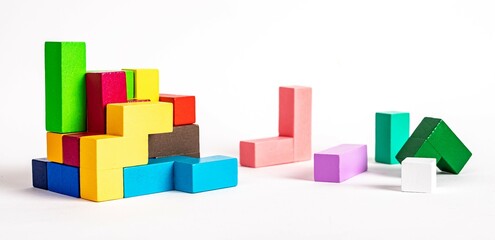 Colorful wooden elements of tetris puzzle. Construction, formation concept. Kids logical game for problem solving skills development. High quality photo