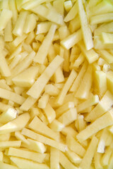 Freshly cut potatoes with straws for cooking close-up