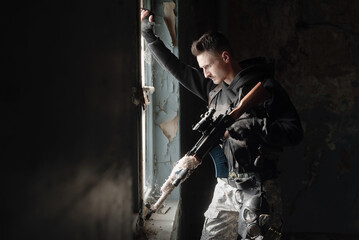 Fototapeta na wymiar Soldier in the abandoned building. Post apocalypse soldier concept.