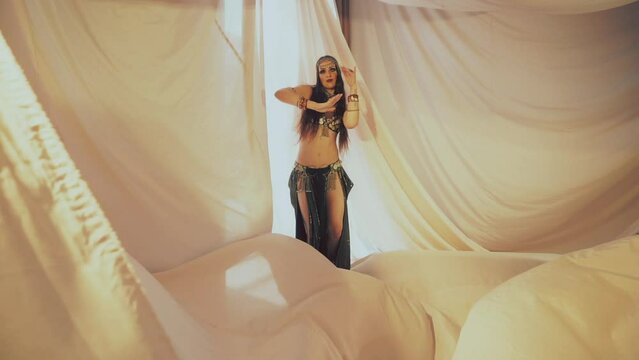 Sensual woman dancing in thin fabrics