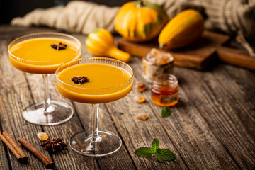 Pumpkin and orange spiced fall cocktail with cinnamon