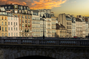 Beautiful scenery on the banks of the Seine River in Paris in the area of the Notre Dame Cathedral under a beautiful sunset sky this city of France is known as the city of love and light.