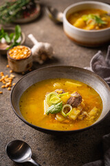 Closeup of a bowl of split pea soup with chunks of ham and meat