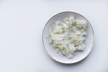 White onion cut into strips on a saucer