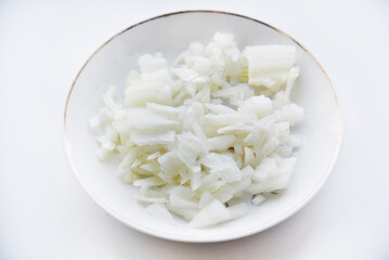 White onion cut into strips on a saucer